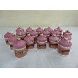 A quantity of Victorian apothecary porcelain jars and covers, pink ground to include original liners