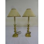 Pair of antique brass candlesticks converted into table lamps, to include shades