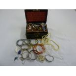 A quantity of costume jewellery to include bangles, rings, necklaces and brooches in leather