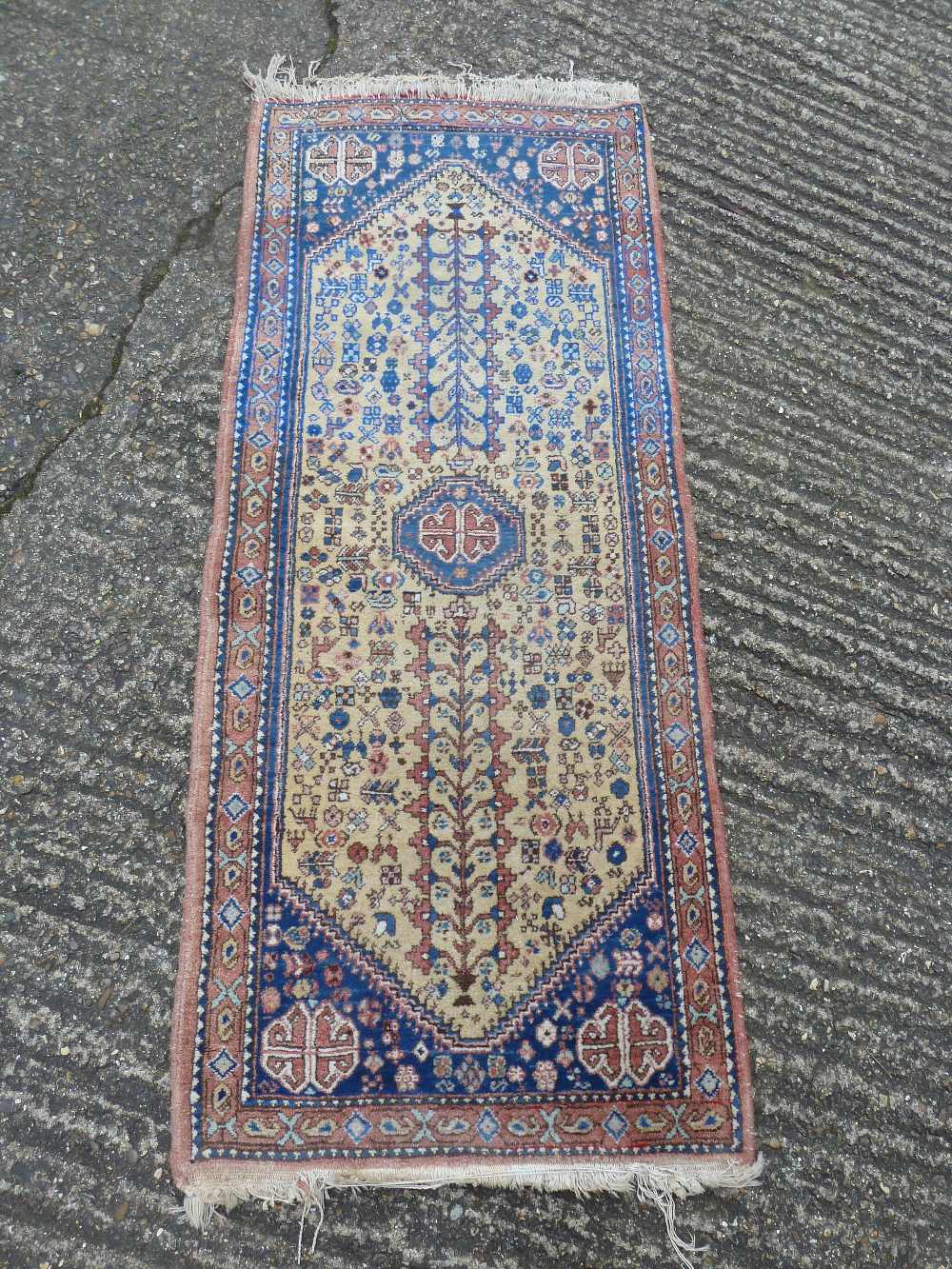 Persian wool runner, geometric medallions on a cream ground with blue and red border, 160 x 67.5cm