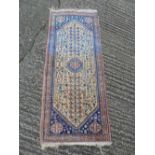 Persian wool runner, geometric medallions on a cream ground with blue and red border, 160 x 67.5cm