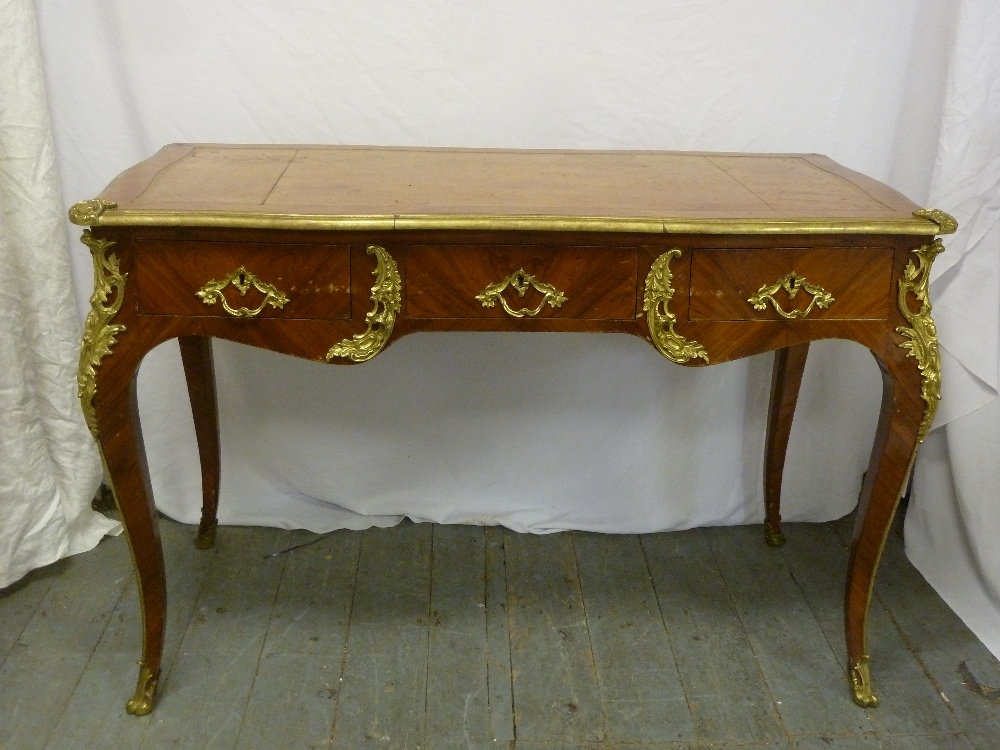 French style desk with tooled leather top, gilt metal  mounts, three drawers on four cabriole legs