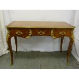 French style desk with tooled leather top, gilt metal  mounts, three drawers on four cabriole legs