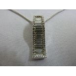18ct white gold diamond pendant set with baguettes and border of small diamonds on an 18ct white