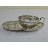 French white metal 1st standard strawberry cup on stand, profusely decorated with flowers scrolls