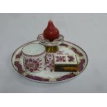 An enamel tray with matching candle holder matchbox and cup