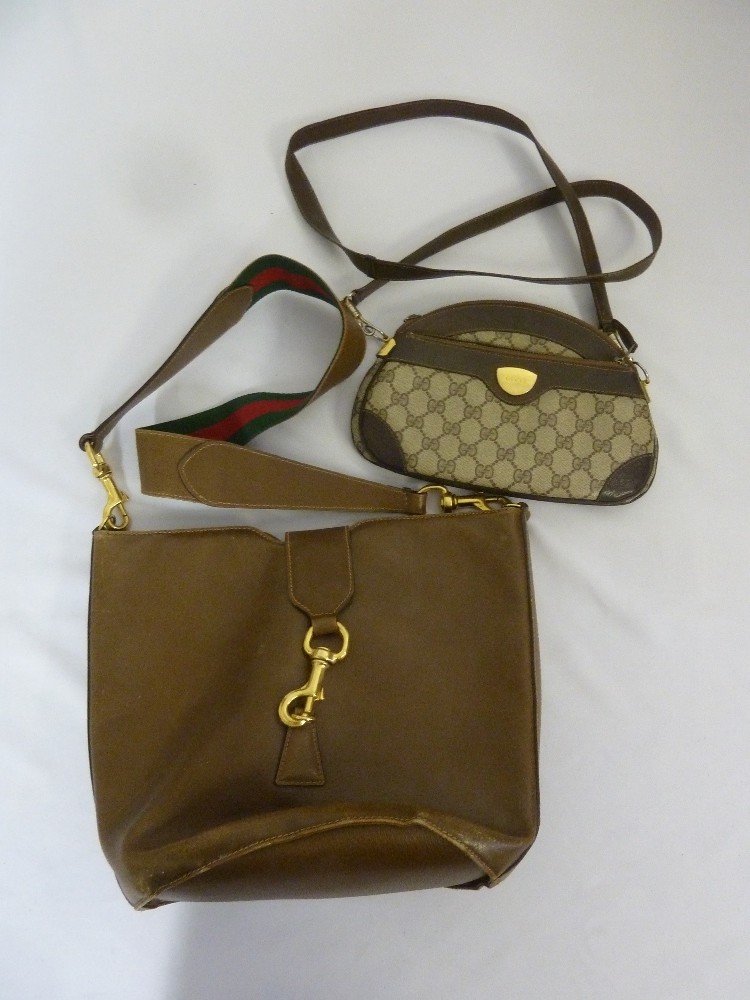 A vintage Gucci leather handbag with red and green shoulder strap and a smaller vintage Gucci bag