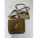 A vintage Gucci leather handbag with red and green shoulder strap and a smaller vintage Gucci bag