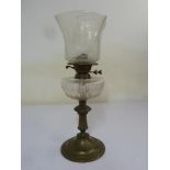 A Victorian brass and glass oil lamp on raised circular base