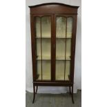 Edwardian glazed double door display case on four tapering legs