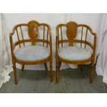 A pair of Biedermeier style inlaid arm chairs with upholstered seats