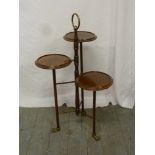 Victorian mahogany plant stand with brass claw feet and central carrying handle