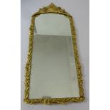 Gilded wall mirror in floral and leaf frame, 111 x 47cm