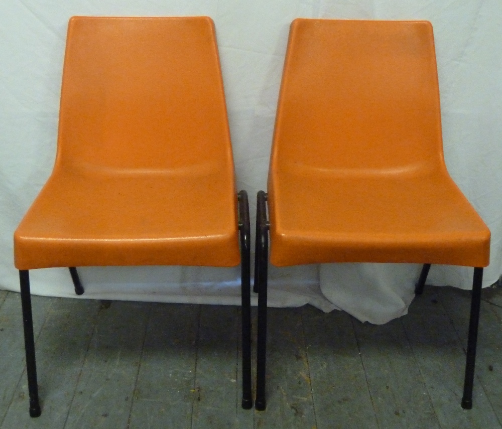 A pair of 1970s moulded orange chairs by Shepherd Furniture