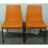 A pair of 1970s moulded orange chairs by Shepherd Furniture