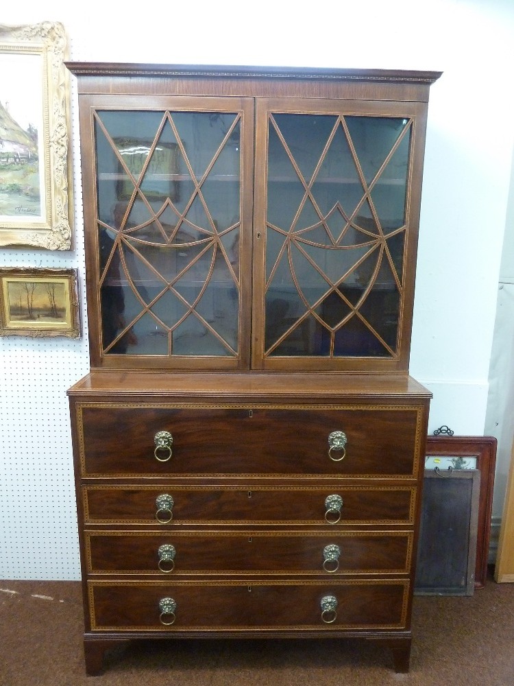 Mahogany bureau breakfront cabinet with glazed top section and four drawers with lion mask ring