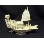 A late 19th century Oriental ivory model of a Junk on raised oval stand