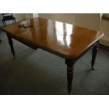 A Victorian rectangular mahogany dining table on four tapering cylindrical legs with Joseph screw