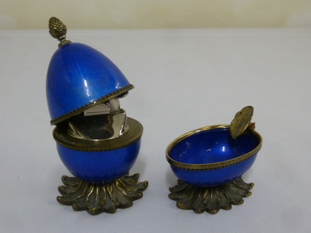 An American gilt metal and enamel table lighter and matching ashtray