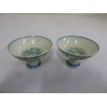 A pair of Chinese early 20th century blue and white stem cups