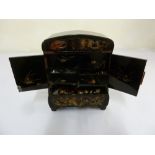 Oriental lacquered curio cabinet of rectangular form on bracket feet, the inside drawers revealing