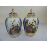 A pair of Dresden hand painted vases and covers, marked AR to the base