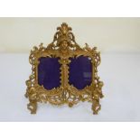 A Victorian gilt metal double picture frame on easel stand