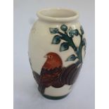 Moorcroft vase decorated with fruit, leaves and a bird