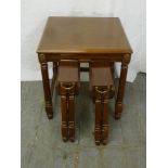 A square mahogany occasional table with two removable drop flap tables