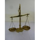 A set of brass balance scales of customary form with weights
