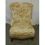 An early 20th century upholstered button back ladies chair on cabriole legs