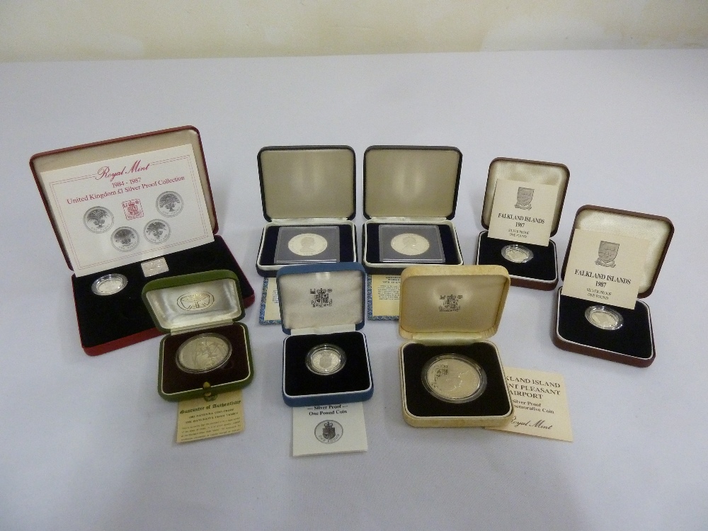 A quantity of silver coins in fitted boxes to include some proof coins (8)