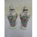 A pair of Chinese style vases with domed pull off covers