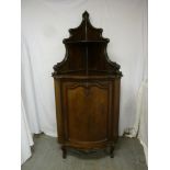 Mahogany corner cabinet with cupboard base and two tier shelf top section on three scroll legs