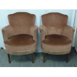 A pair of upholstered Art Deco tub chairs on four rectangular legs