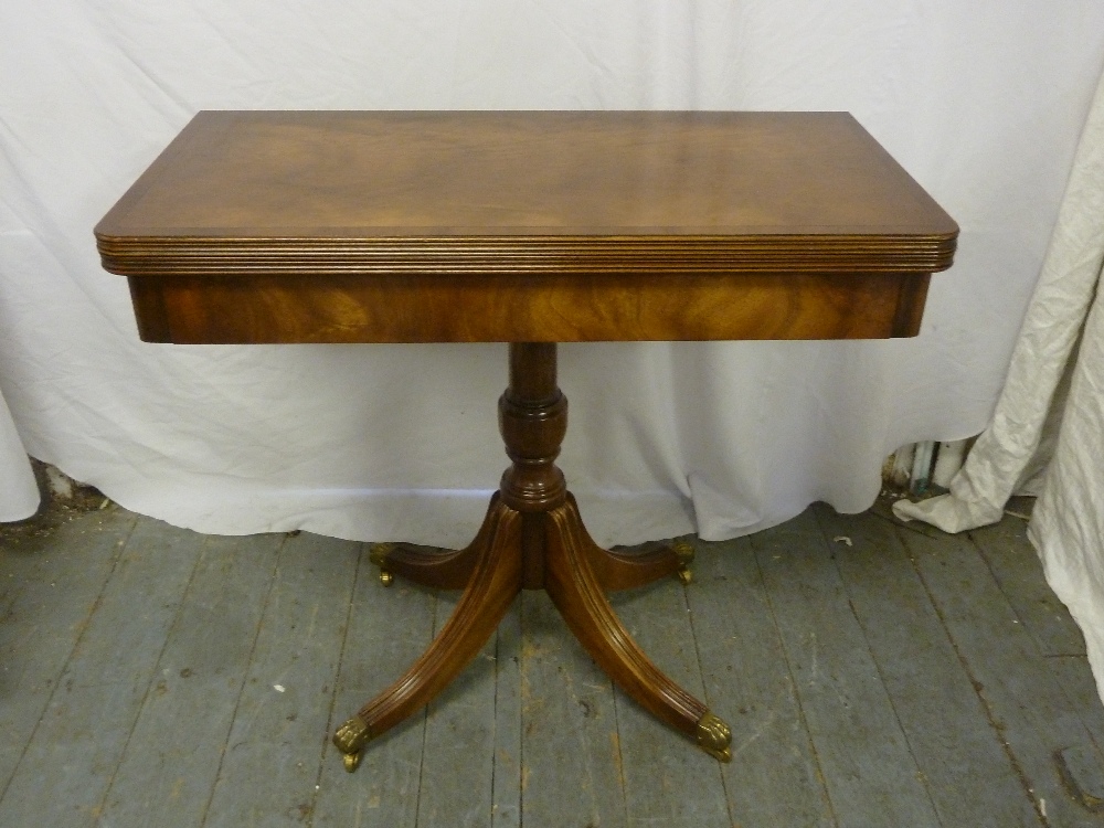 Reproduction mahogany card table on quatrefoil base