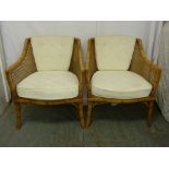 A pair of bergere conservatory chairs with upholstered seats and backs
