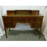 Edwardian mahogany desk with gallery and tooled leather inset, swing handles on four tapering legs