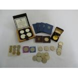 A quantity of British and foreign coins to include proof sets, blue decimal sets, 1951 crown and