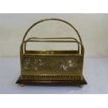 A Victorian brass magazine rack mounted on raised wooden base with decorative side panels
