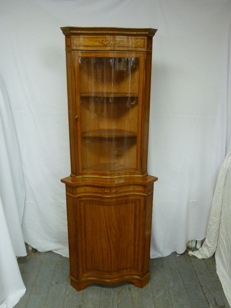 Serpentine front corner cabinet with glazed top section and cupboard base