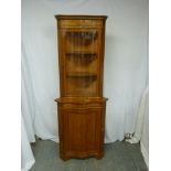 Serpentine front corner cabinet with glazed top section and cupboard base