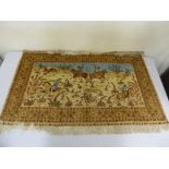 Persian silk wall hanging depicting huntsman on horse within a scroll and medallion border, signed