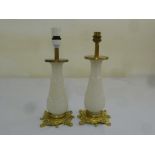 A pair of French milk glass lamps with Ormolu bases and mounts