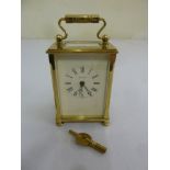Dominion brass and glass carriage clock of customary form to include key