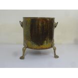 A Victorian cylindrical brass coal scuttle on three scroll legs