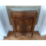 A French inlaid Kingswood commode with painted hinged double doors and applied brass mounts with