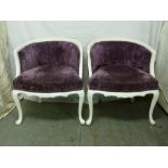 A pair of upholstered armchairs in the French style on four cabriole legs