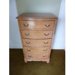 A rectangular mahogany chest of five drawers with brass handles on bracket feet