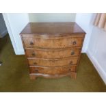 A 19th century mahogany serpentine fronted chest of four drawers with brass swing handles on bracket